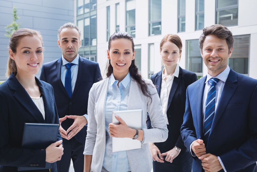 confident-businesspeople-standing-outside-office-building-1024x683